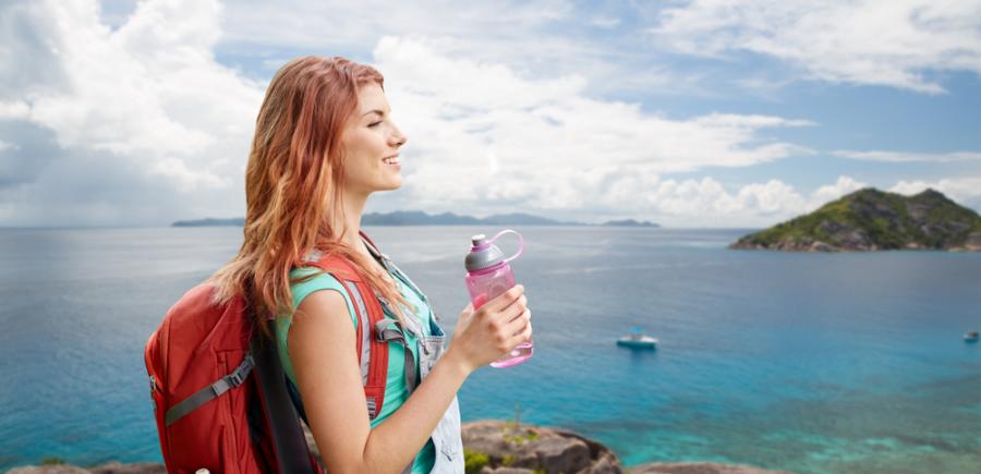 Woman hiking with a water bottle in hand