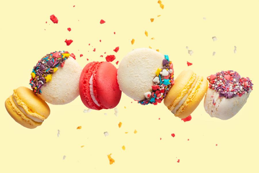 Colorful macarons on a yellow background