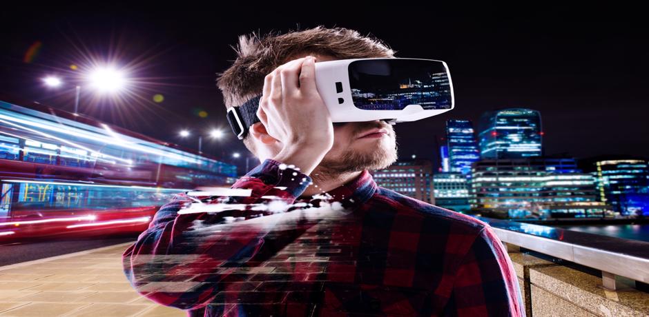 Man wearing virtual reality goggles on a subway platform