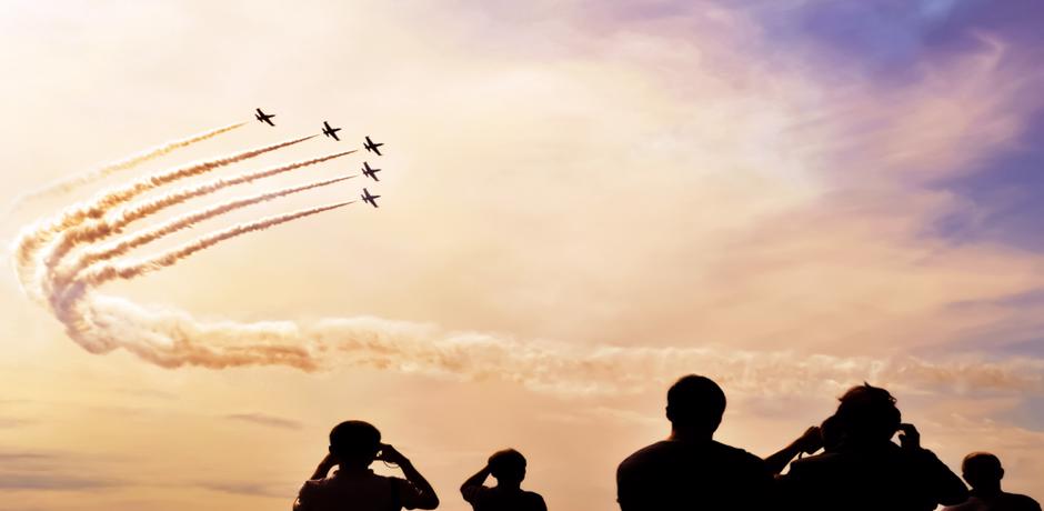 people watching aircraft flying 