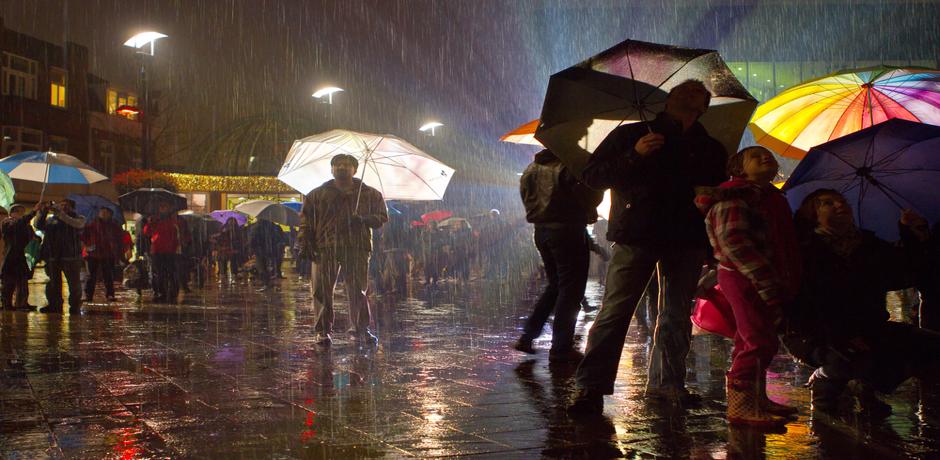 People holding umbrellas in the rain