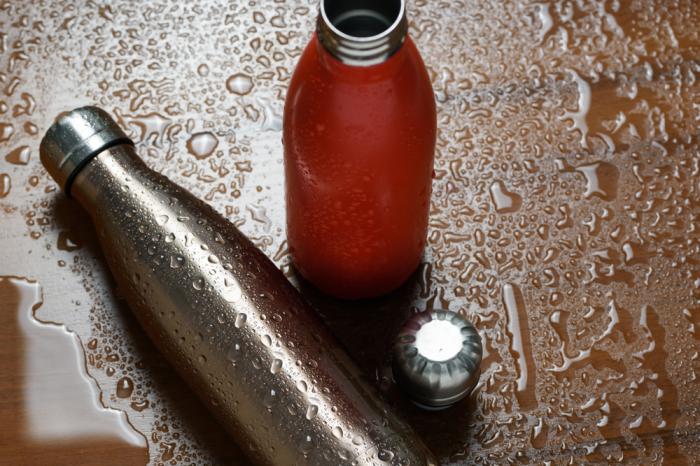 water bottle on a rained wood surface