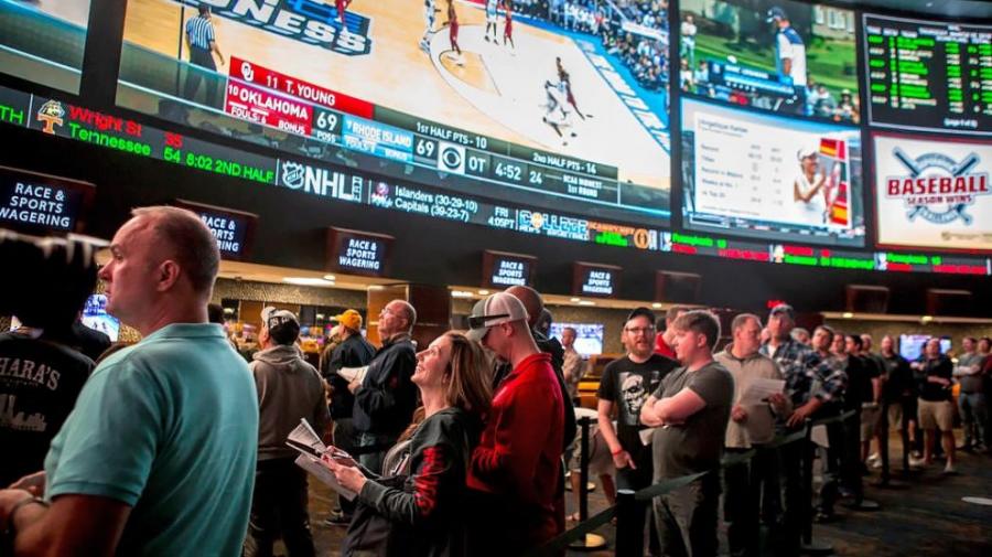 Crowd of people waiting in line to make a sports bet