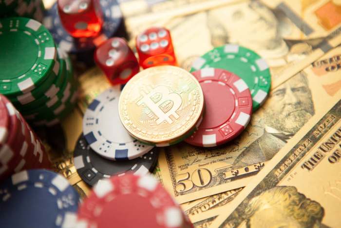 Colorful casino chips, dollars, bitcoins and red dice