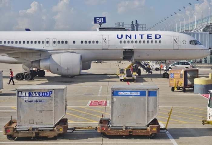 CHICAGO, IL -16 MAY 2015- Baggage containers marked Continental Airlines and United Airlines on the tarmac at Chicago OHare International Airport (ORD). The two companies fully merged in 2012.