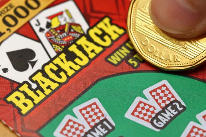 Coquitlam BC Canada - October 24, 2015 : Woman scratching lottery tickets. The British Columbia Lottery Corporation has provided government sanctioned lottery games in British Columbia since 1985.