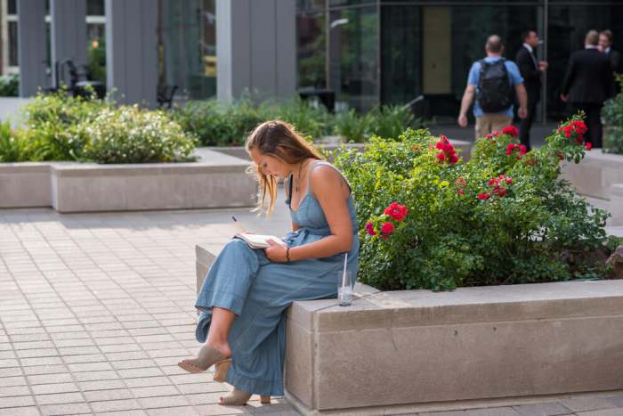 Chicago, IL, August 5, 2017: A student takes a moment to study downtown. There are more than 20 colleges in the Loop, contributing to Chicago being named the 'biggest college town in Illinois' in 2010