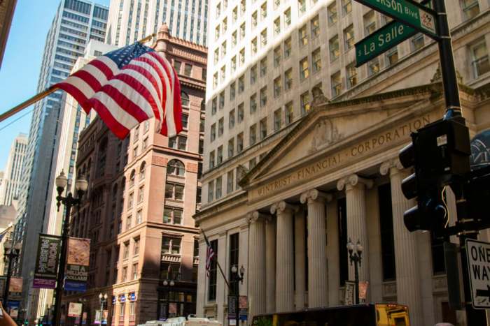 The financial district of Chicago downtown business sector. the american flag is on display near the Wintrust financial Corporation building near Jackson and La Salle.