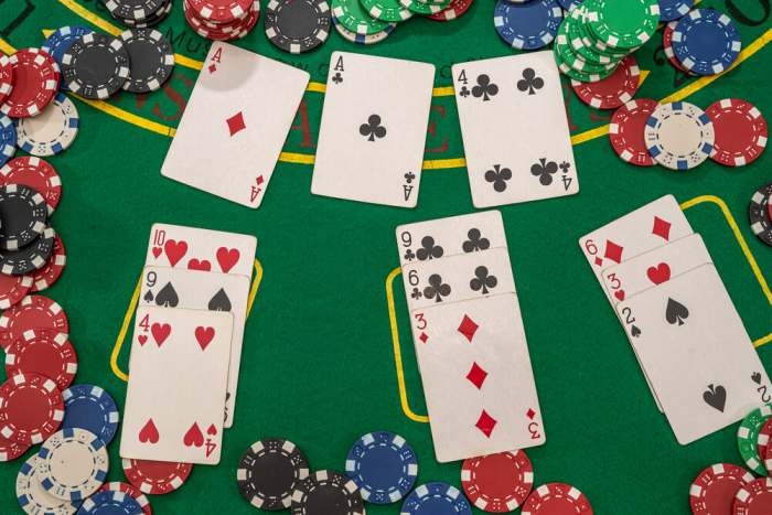 card games popular among chicagoans picture of poker chips with play cards on the green casino table. gambling