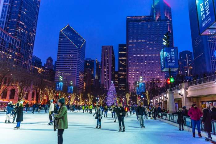People are enjoying ice skating during beautiful winter night in Millennium Park Ice Rink
